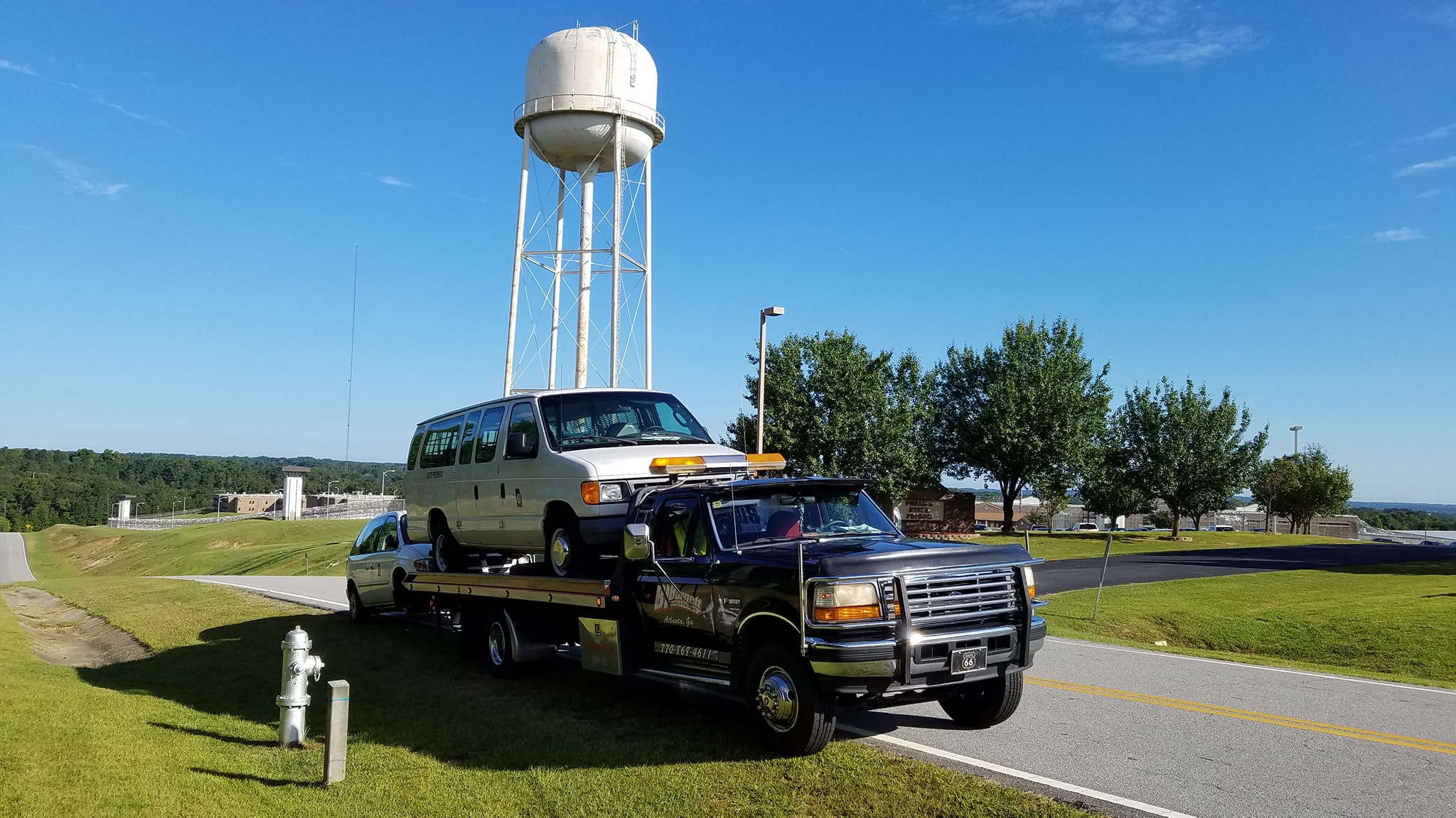 White van on back of tow truck