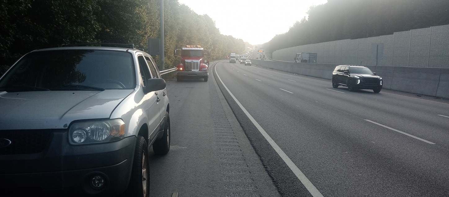 Tow truck on side of highway.