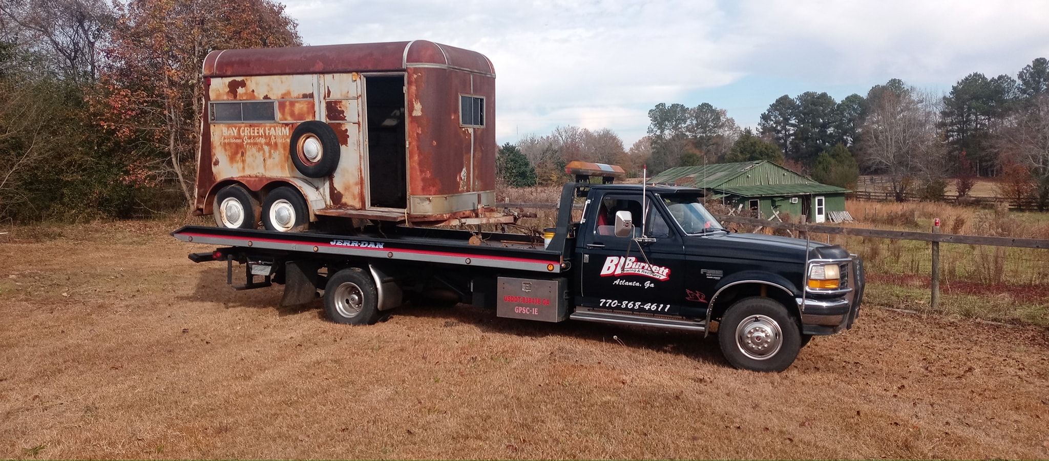 Bay creek farm trailer on top of BL Burnett towing truck